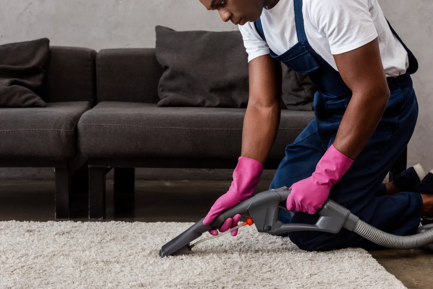 A worker lining and cleaning the carpet of the house.
